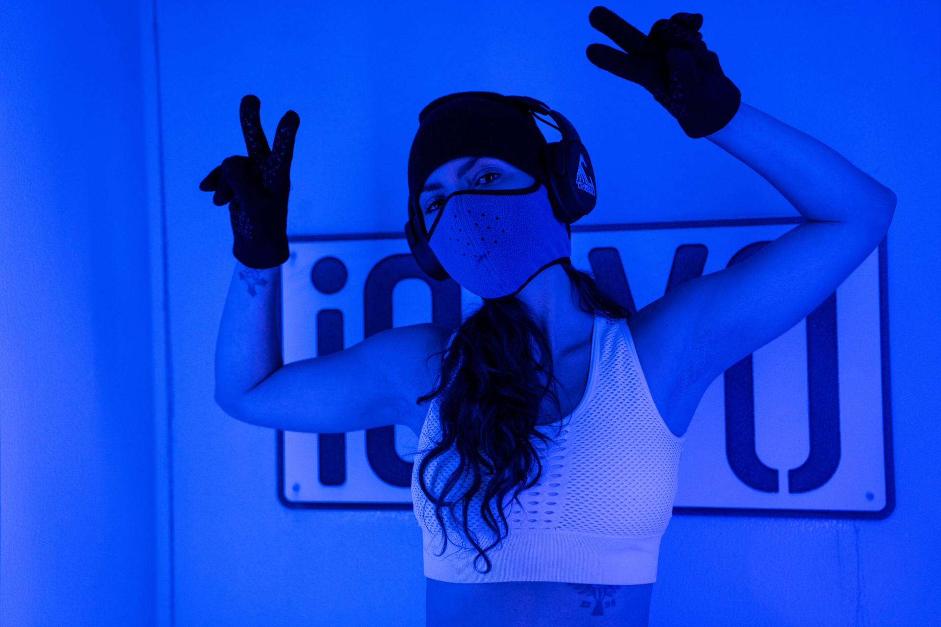 Person experiencing whole body cryotherapy session with blue nitrogen vapor
