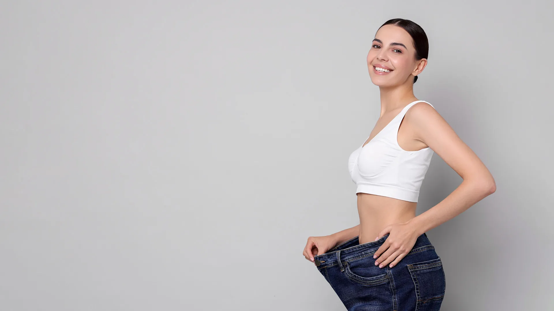 Woman celebrating weight loss results at iCRYO Clemson Medical Weight Loss program